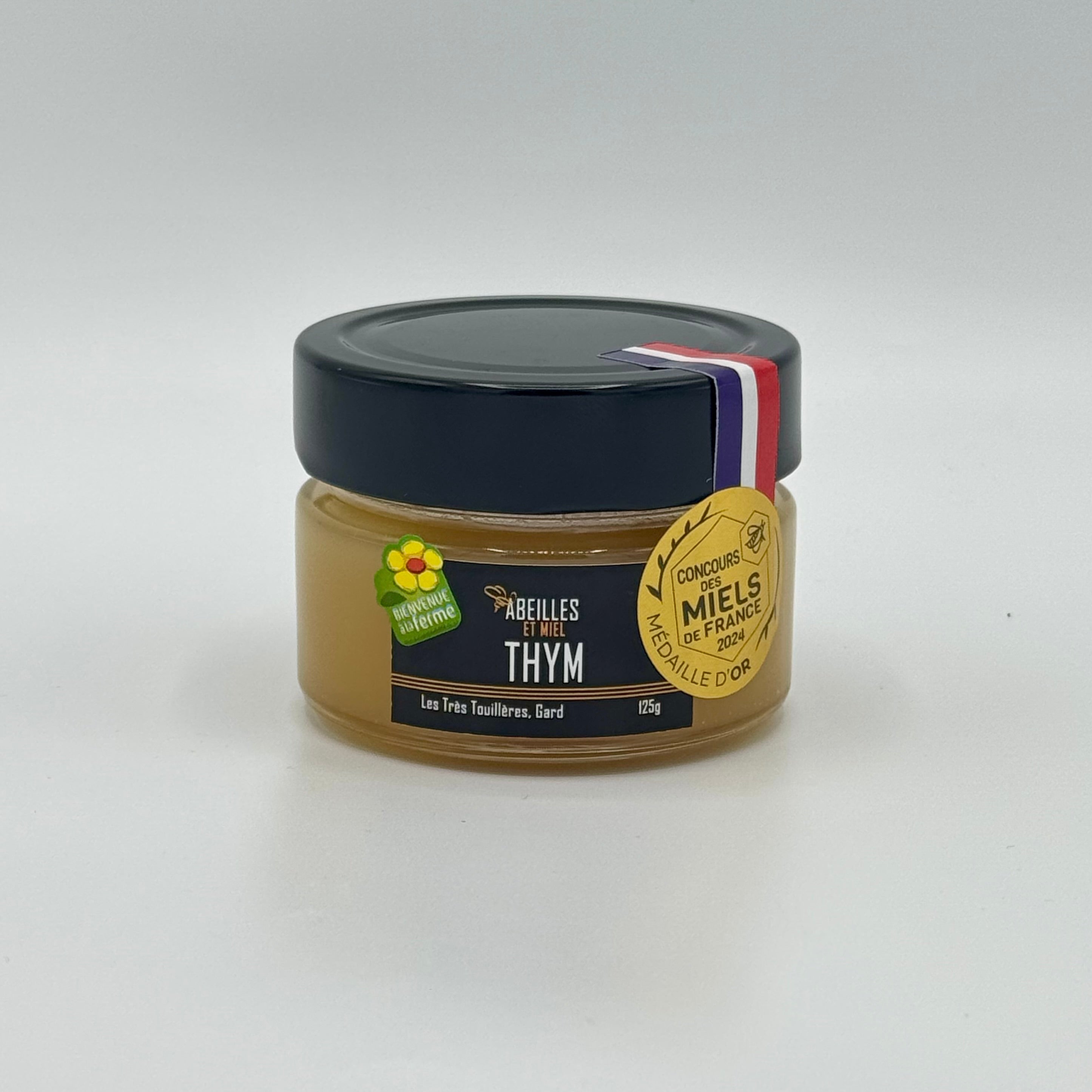 Pot de miel de thym français au goût puissant et aux arômes herbacés.