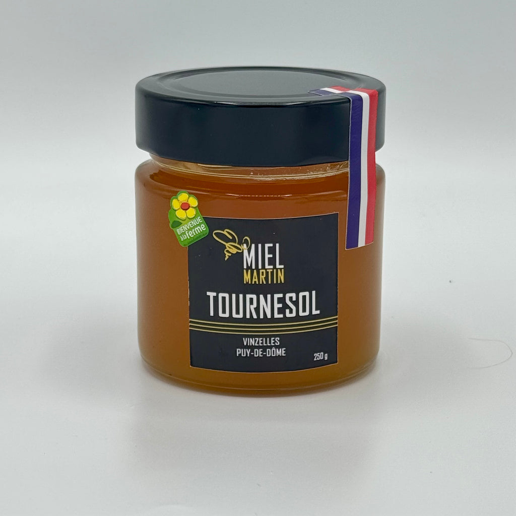 Pot de miel de tournesol produit par Abeilles et Miel, à la couleur jaune claire et à la texture crémeuse, idéal pour le petit-déjeuner et les recettes sucrées.