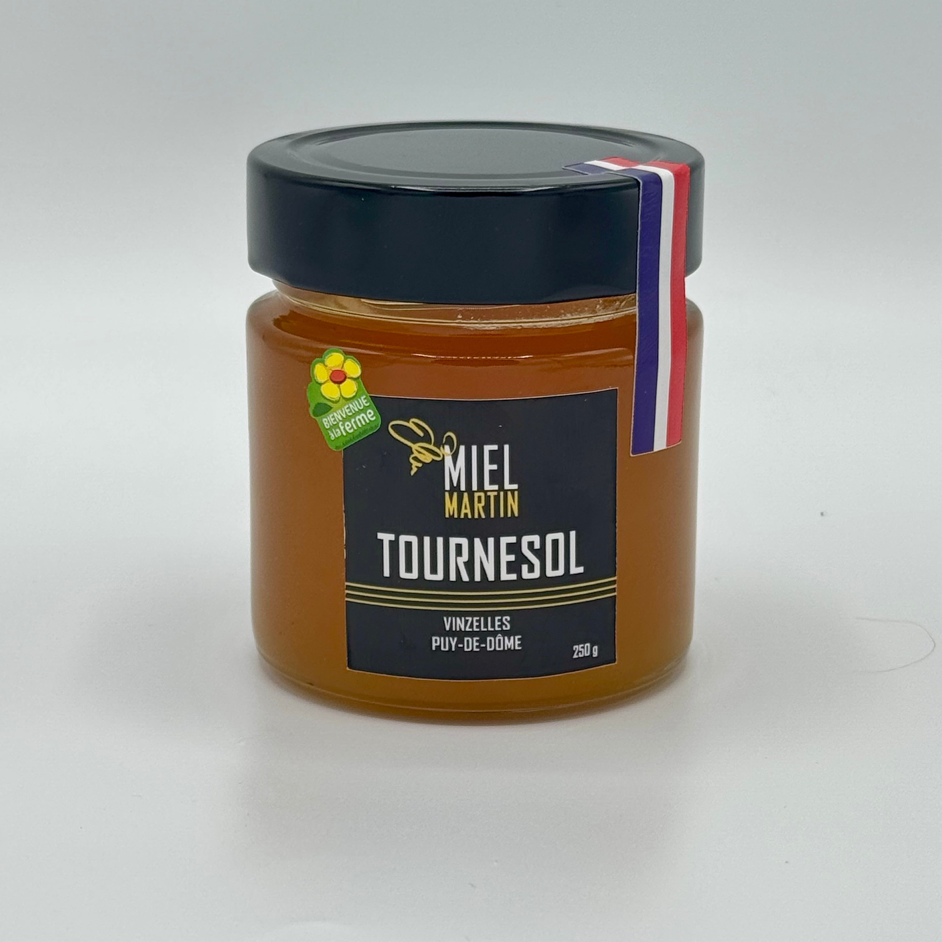 Pot de miel de tournesol produit par Abeilles et Miel, à la couleur jaune claire et à la texture crémeuse, idéal pour le petit-déjeuner et les recettes sucrées.